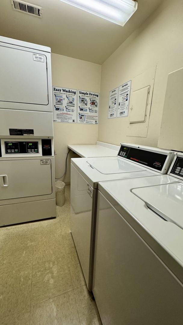 communal laundry room featuring washing machine and dryer and stacked washer / drying machine
