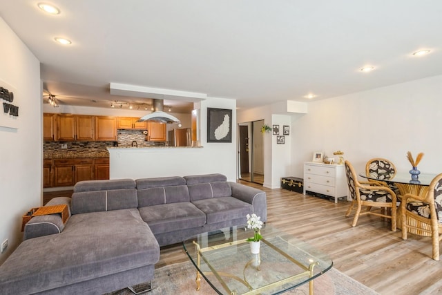 living room with light wood-style flooring and recessed lighting