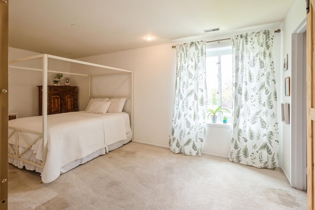 bedroom with multiple windows and carpet