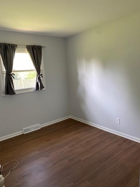 950 Arlon Rd, Aurora, IL 60506 - spare room with baseboards and dark wood-style floors