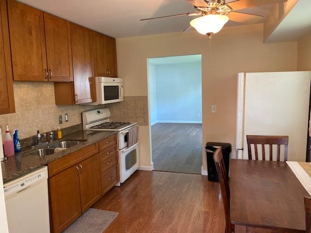 950 Arlon Rd, Aurora, IL 60506 - kitchen featuring white appliances, a sink, a ceiling fan, dark wood finished floors, and brown cabinets