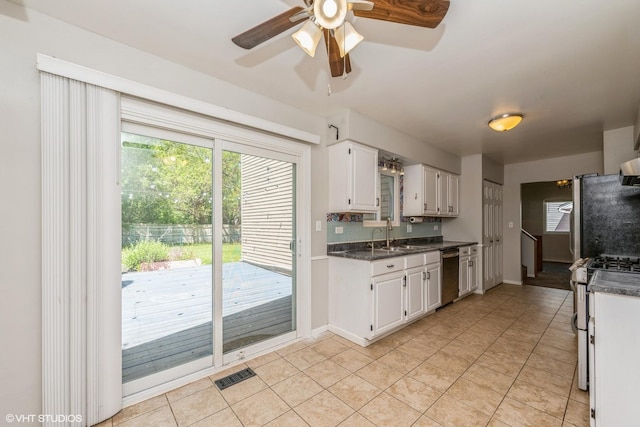 618 Hampton Cir, Elgin, IL 60120 - kitchen featuring appliances with stainless steel finishes, dark countertops, light tile patterned floors, and white cabinetry