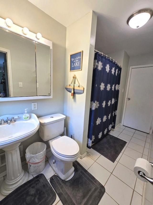 bathroom with tile patterned flooring, curtained shower, and toilet