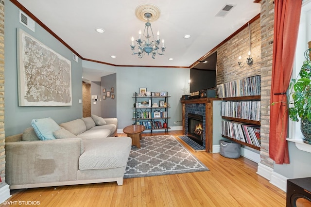 living area featuring a fireplace with flush hearth, wood finished floors, baseboards, ornamental molding, and recessed lighting