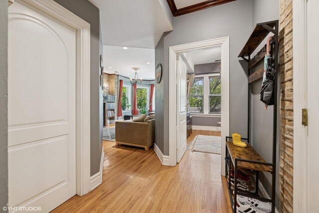 3515 W Medill Ave Unit 1W, Chicago, IL 60647 - hallway with light wood finished floors, baseboards, a chandelier, crown molding, and recessed lighting