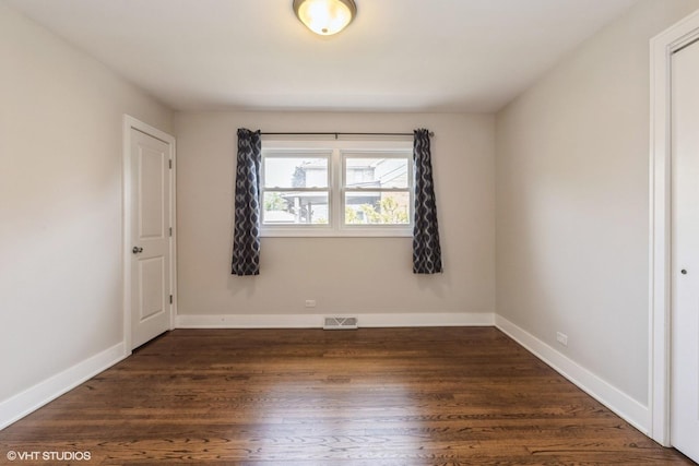 8128 N Odell Ave, Niles, IL 60714 - spare room with dark wood-style floors and baseboards