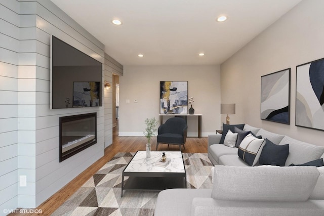 8128 N Odell Ave, Niles, IL 60714 - living room featuring recessed lighting, a large fireplace, wood finished floors, and baseboards