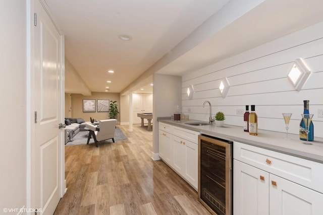 8128 N Odell Ave, Niles, IL 60714 - bar area with beverage cooler, a sink, light wood-type flooring, and recessed lighting