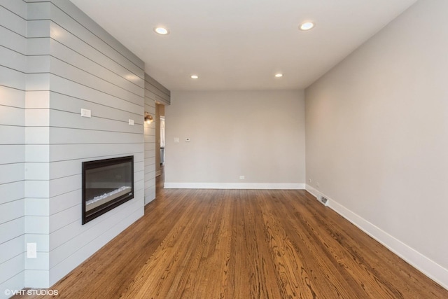 8128 N Odell Ave, Niles, IL 60714 - unfurnished living room featuring recessed lighting, wood finished floors, baseboards, and a large fireplace