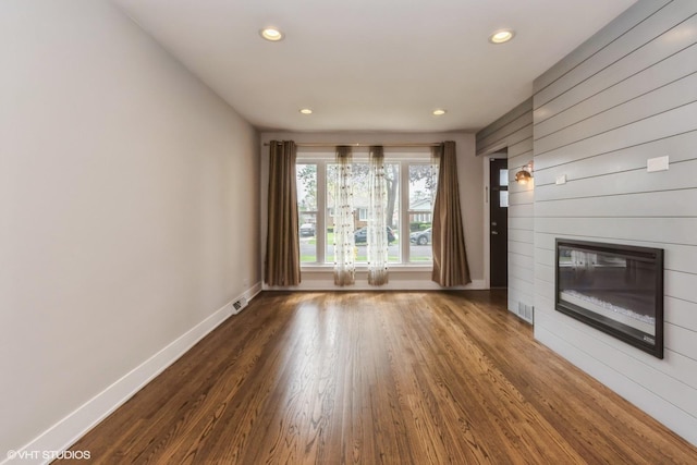 8128 N Odell Ave, Niles, IL 60714 - unfurnished living room featuring recessed lighting, baseboards, wood finished floors, and a glass covered fireplace