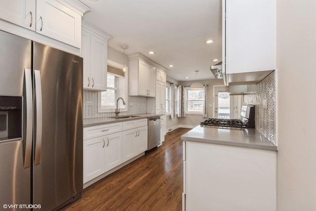 8128 N Odell Ave, Niles, IL 60714 - kitchen featuring appliances with stainless steel finishes, a sink, white cabinets, decorative backsplash, and recessed lighting