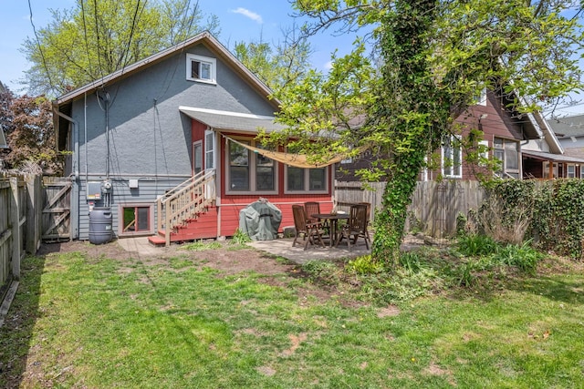 rear view of property featuring a patio area