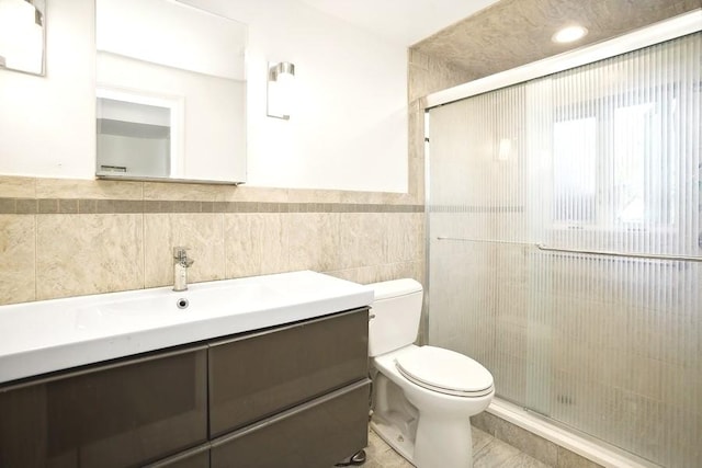 735 Lamon Ave, Wilmette, IL 60091 - bathroom featuring toilet, tile walls, a shower stall, vanity, and wainscoting