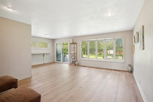 735 Lamon Ave, Wilmette, IL 60091 - unfurnished living room featuring wood finished floors, baseboards, and recessed lighting