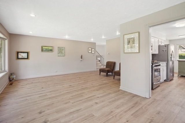 735 Lamon Ave, Wilmette, IL 60091 - living area with light wood finished floors, baseboards, stairway, and recessed lighting