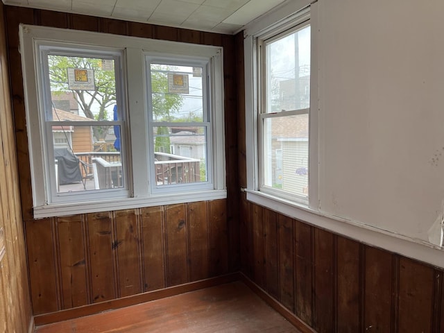 3423 N Tripp Ave, Chicago, IL 60641 - unfurnished dining area featuring wooden walls and wood finished floors
