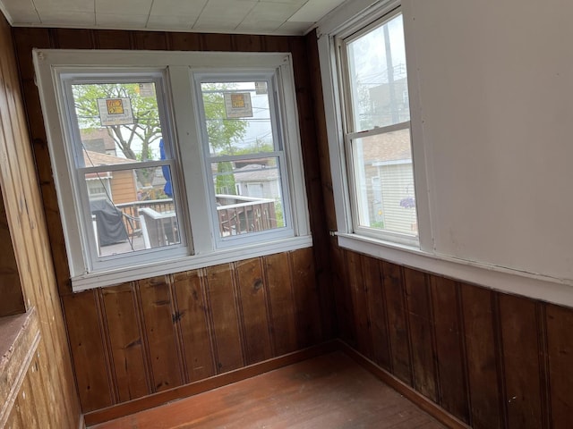 3423 N Tripp Ave, Chicago, IL 60641 - unfurnished dining area featuring wooden walls, healthy amount of natural light, and wood finished floors