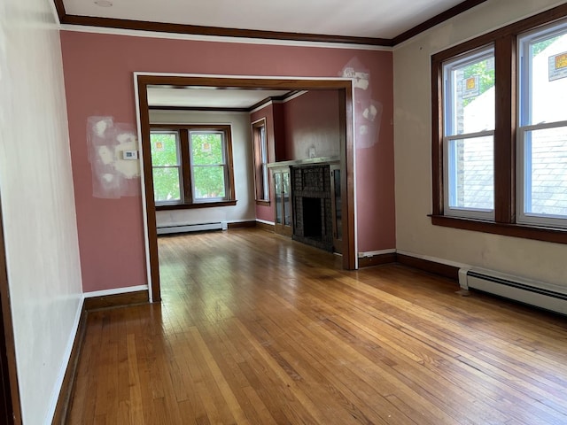3423 N Tripp Ave, Chicago, IL 60641 - unfurnished living room featuring ornamental molding, a baseboard heating unit, hardwood / wood-style floors, baseboards, and a fireplace