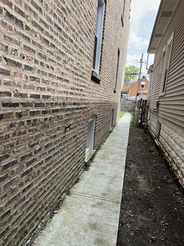 3423 N Tripp Ave, Chicago, IL 60641 - view of side of home with brick siding and fence