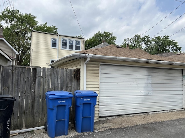 3423 N Tripp Ave, Chicago, IL 60641 - view of property exterior with roof with shingles, fence, and a garage