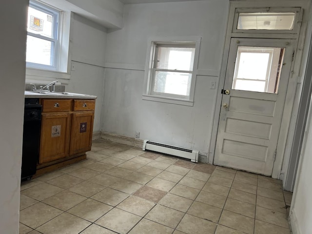 3423 N Tripp Ave, Chicago, IL 60641 - kitchen featuring a baseboard heating unit, brown cabinets, light tile patterned floors, and a sink