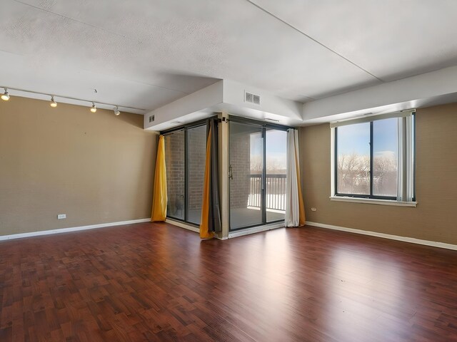 500 Park Ave Unit 535, Calumet City, IL 60409 - spare room with baseboards, rail lighting, and wood finished floors