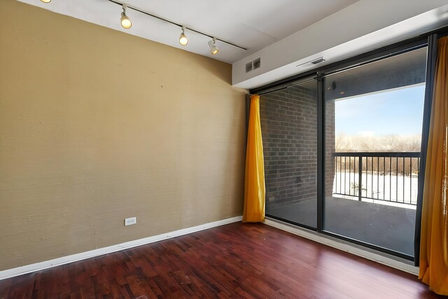 500 Park Ave Unit 535, Calumet City, IL 60409 - spare room with healthy amount of natural light, wood finished floors, baseboards, and rail lighting