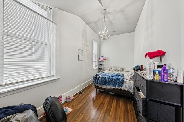 2443 N Marshfield Ave, Chicago, IL 60614 - bedroom featuring multiple windows, wood finished floors, a chandelier, baseboards, and lofted ceiling