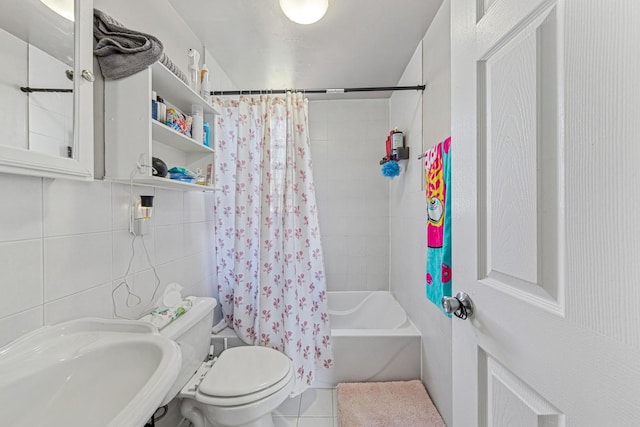 2443 N Marshfield Ave, Chicago, IL 60614 - bathroom with shower / tub combo, toilet, a sink, tile patterned flooring, and tile walls