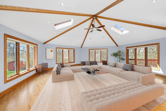 16608 W 135th St, Lemont, IL 60439 - living room featuring a skylight, baseboards, wood finished floors, and recessed lighting