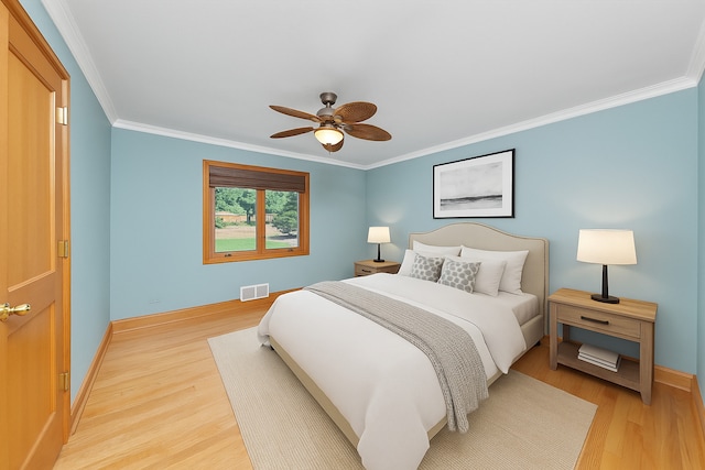 16608 W 135th St, Lemont, IL 60439 - bedroom with light wood-style floors, ornamental molding, baseboards, and ceiling fan