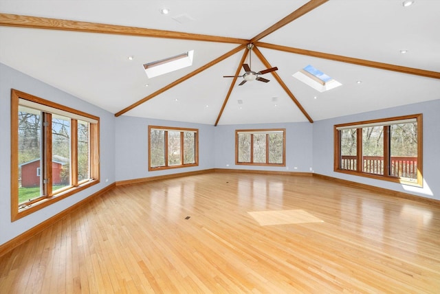 16608 W 135th St, Lemont, IL 60439 - unfurnished living room with a skylight, beam ceiling, baseboards, healthy amount of natural light, and high vaulted ceiling