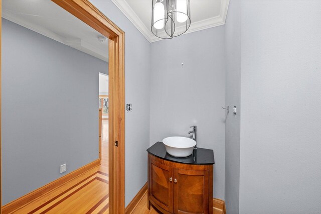 16608 W 135th St, Lemont, IL 60439 - bathroom with crown molding, vanity, wood finished floors, a chandelier, and baseboards