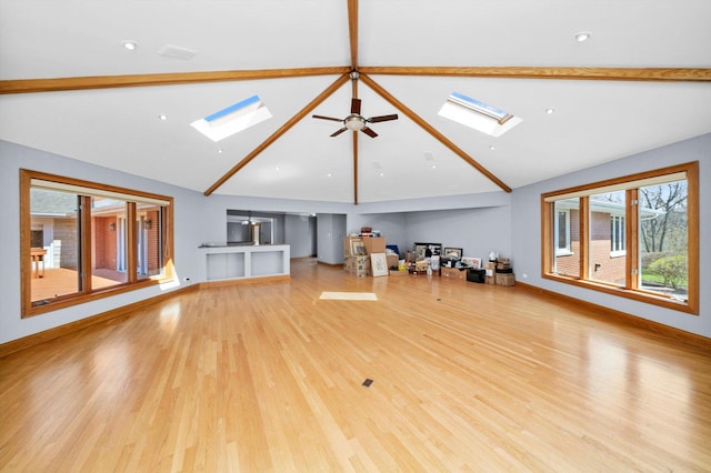 16608 W 135th St, Lemont, IL 60439 - unfurnished living room featuring a skylight, beamed ceiling, wood finished floors, high vaulted ceiling, and ceiling fan
