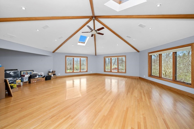 16608 W 135th St, Lemont, IL 60439 - unfurnished living room with a skylight, beam ceiling, high vaulted ceiling, light wood finished floors, and a ceiling fan