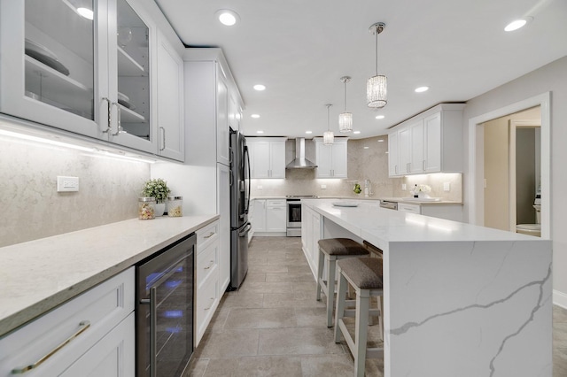 1409 Burr Oak Rd Unit 109A, Hinsdale, IL 60521 - kitchen with wine cooler, wall chimney range hood, stainless steel appliances, decorative backsplash, and a center island