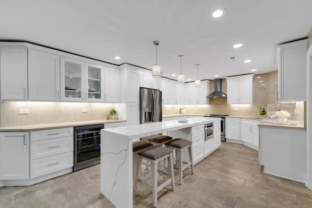 1409 Burr Oak Rd Unit 109A, Hinsdale, IL 60521 - kitchen with stainless steel appliances, wine cooler, wall chimney range hood, a center island, and white cabinetry