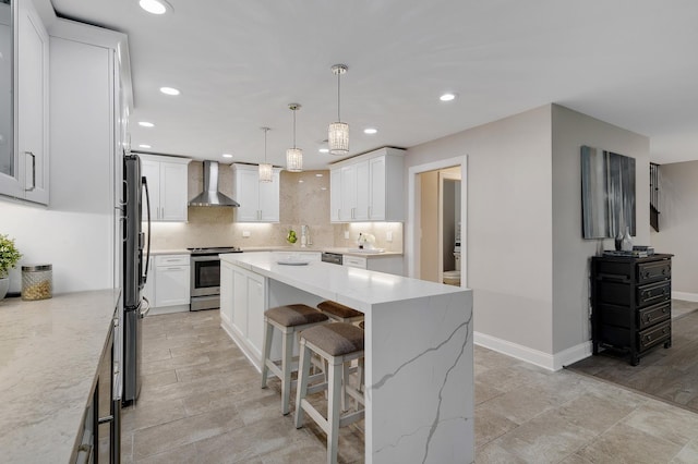 1409 Burr Oak Rd Unit 109A, Hinsdale, IL 60521 - kitchen with stainless steel appliances, wall chimney exhaust hood, a breakfast bar area, a kitchen island, and decorative backsplash