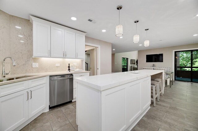 1409 Burr Oak Rd Unit 109A, Hinsdale, IL 60521 - kitchen featuring dishwasher, a sink, white cabinetry, a kitchen island, and hanging light fixtures