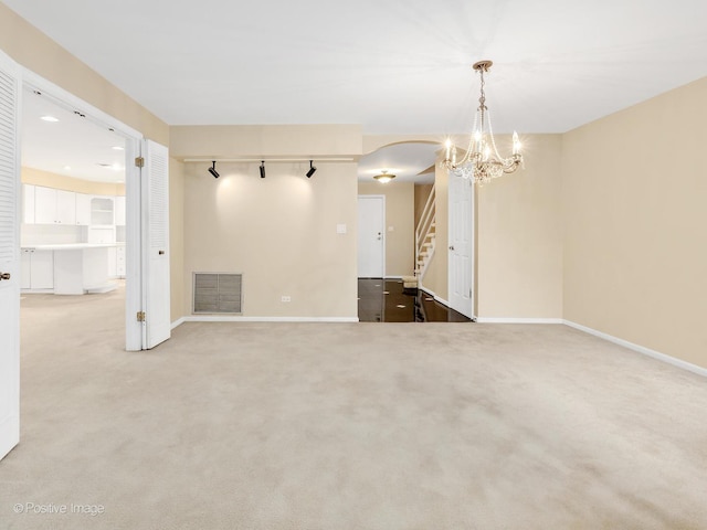 1409 Burr Oak Rd Unit 109A, Hinsdale, IL 60521 - carpeted spare room with stairs, a chandelier, and baseboards