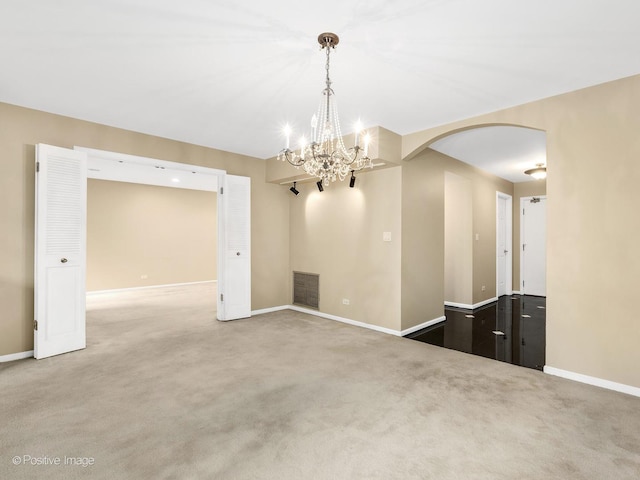 1409 Burr Oak Rd Unit 109A, Hinsdale, IL 60521 - unfurnished dining area featuring arched walkways, baseboards, a chandelier, and carpet