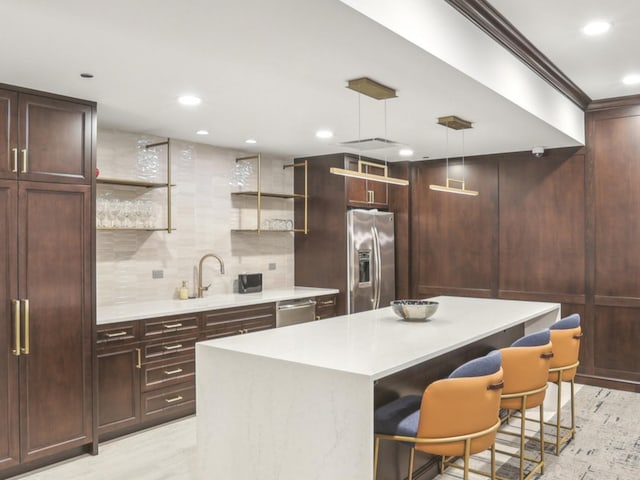 kitchen featuring stainless steel appliances, open shelves, a kitchen island, light countertops, and recessed lighting