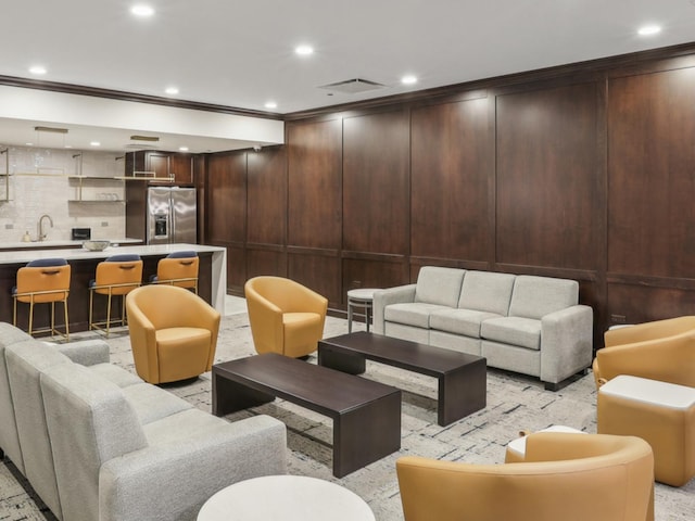 lobby with a sink, recessed lighting, and crown molding