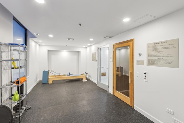 hallway with baseboards and recessed lighting