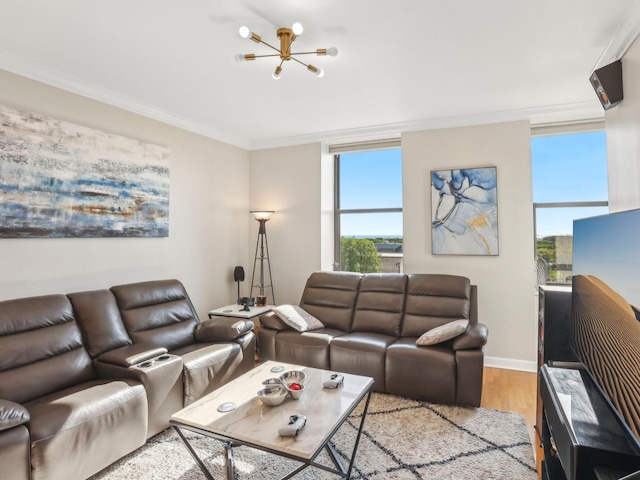 living area with light wood finished floors, crown molding, a chandelier, and baseboards