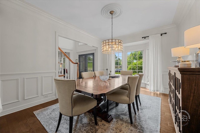 3722 Saint Germain Pl, Saint Charles, IL 60175 - dining area featuring a chandelier, ornamental molding, dark wood-style flooring, a decorative wall, and wainscoting