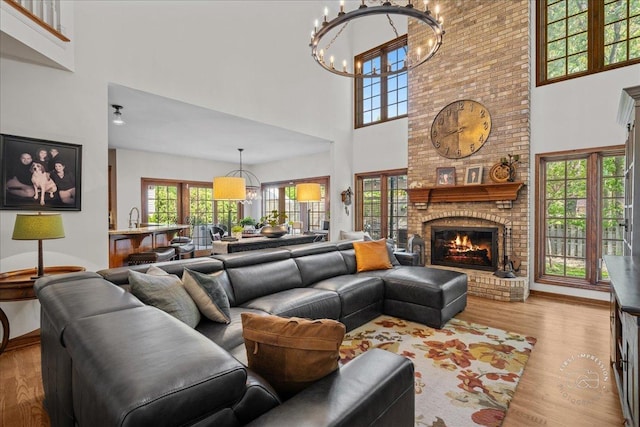 3722 Saint Germain Pl, Saint Charles, IL 60175 - living area with a high ceiling, a chandelier, wood finished floors, a fireplace, and baseboards