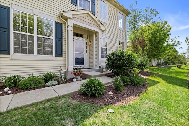 698 S Jade Ln Unit 698, Round Lake, IL 60073 - view of exterior entry with a lawn