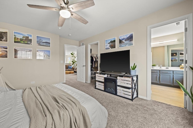 698 S Jade Ln Unit 698, Round Lake, IL 60073 - bedroom featuring light carpet, connected bathroom, a walk in closet, ceiling fan, and a closet