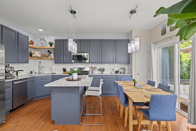 698 S Jade Ln Unit 698, Round Lake, IL 60073 - kitchen featuring appliances with stainless steel finishes, a sink, open shelves, backsplash, and recessed lighting